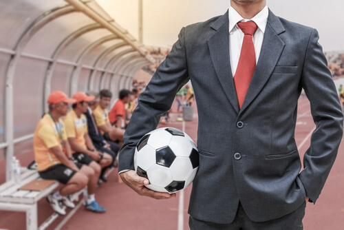 Sports Management Degree - Man holding soccer ball.